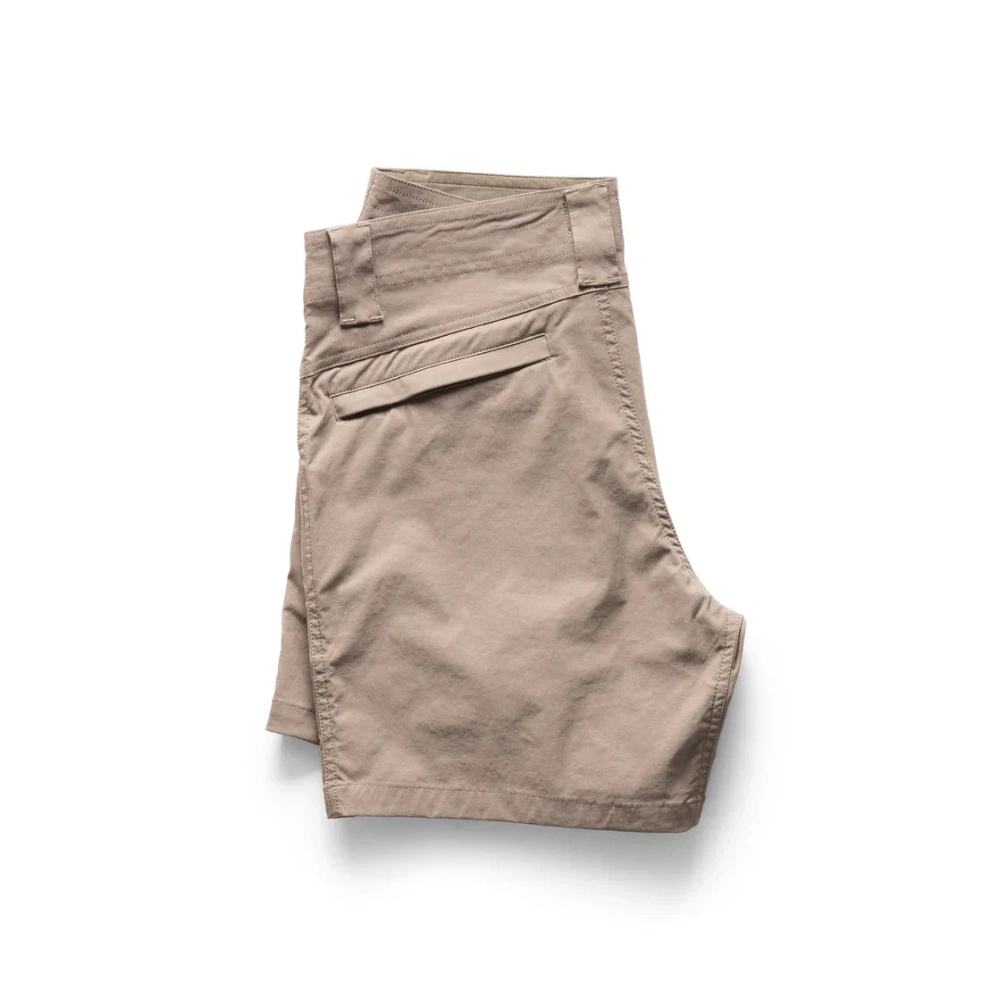 Folded beige chino shorts on a white background, showing one back pocket