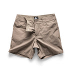 Beige shorts with a brand label on a white background