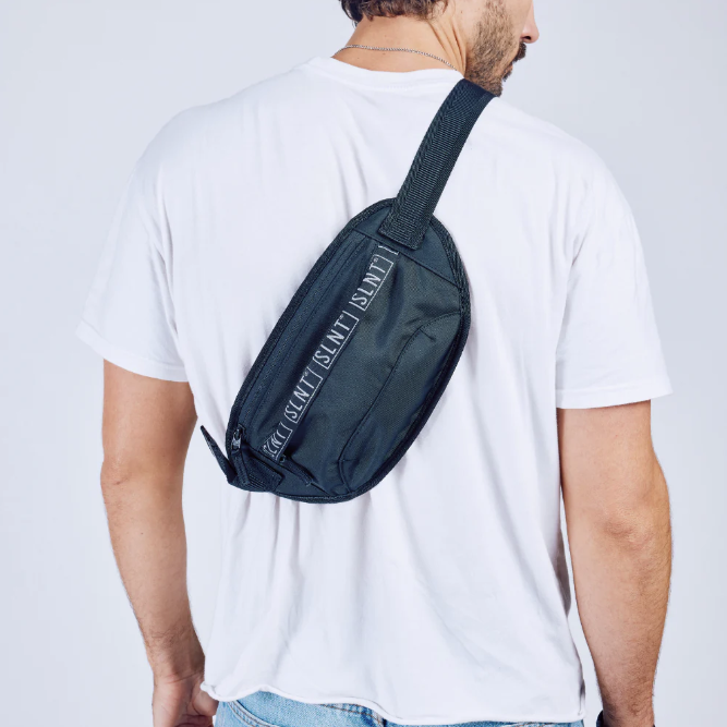 Man Carrying Black & Grey Faraday Fanny Pack Over Shoulder