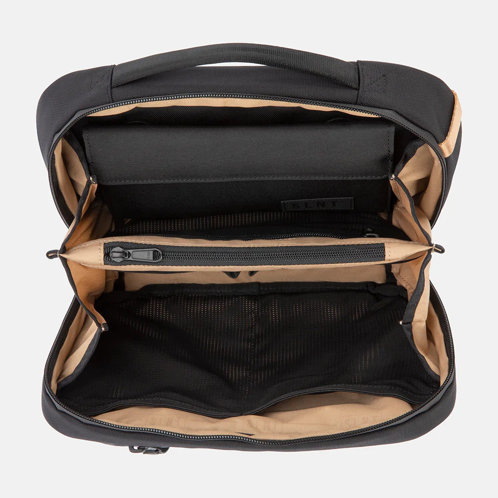 Opened SLNT E3 Faraday Crossbody Organizer Bag from above, showing faraday insert at the top, a zip pocket in the middle and mesh pockets in the bottom section